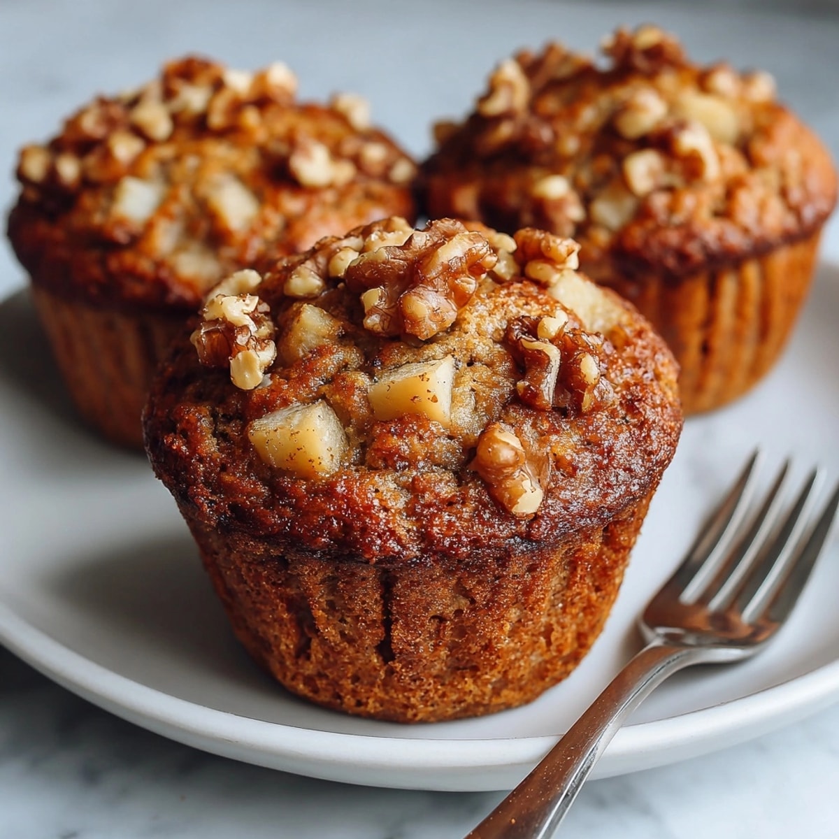Close-up of glazed Apple Walnut Breakfast Muffins – perfect for a cozy brunch treat.
