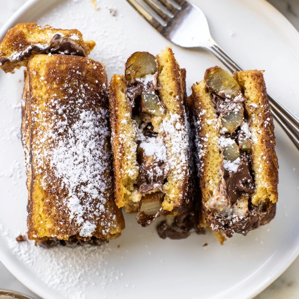 Golden-brown S’mores Pickle French Toast Sticks filled with chocolate and marshmallows.  
