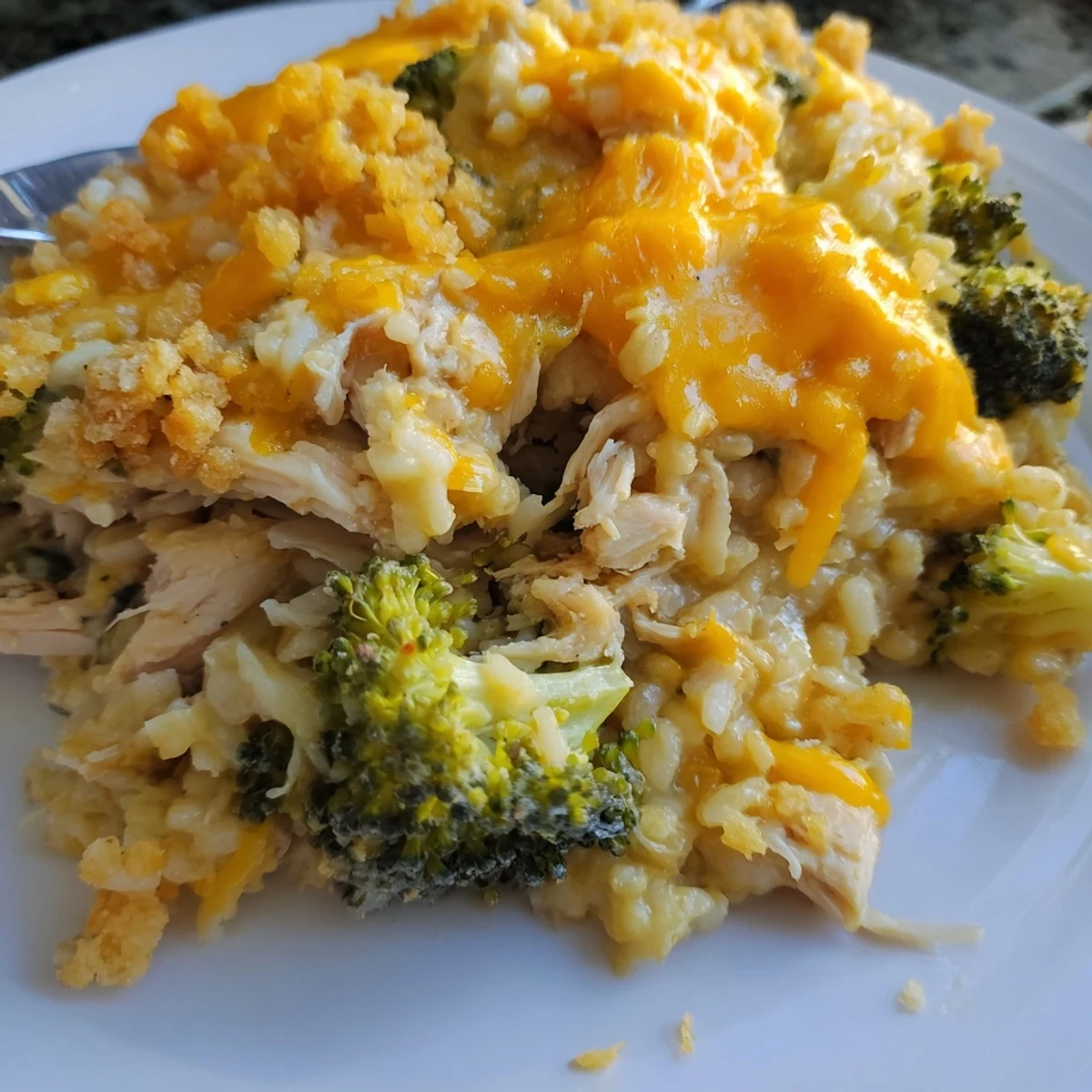 Hearty broccoli, rice, chicken, and cheese casserole served in a cozy bowl, perfect for dinner.