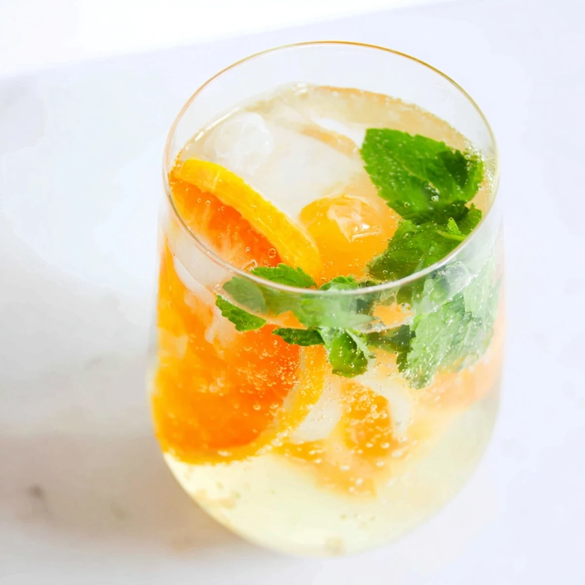 Refreshing probiotic soda mocktail with citrus and mint, perfect for summer gatherings.  