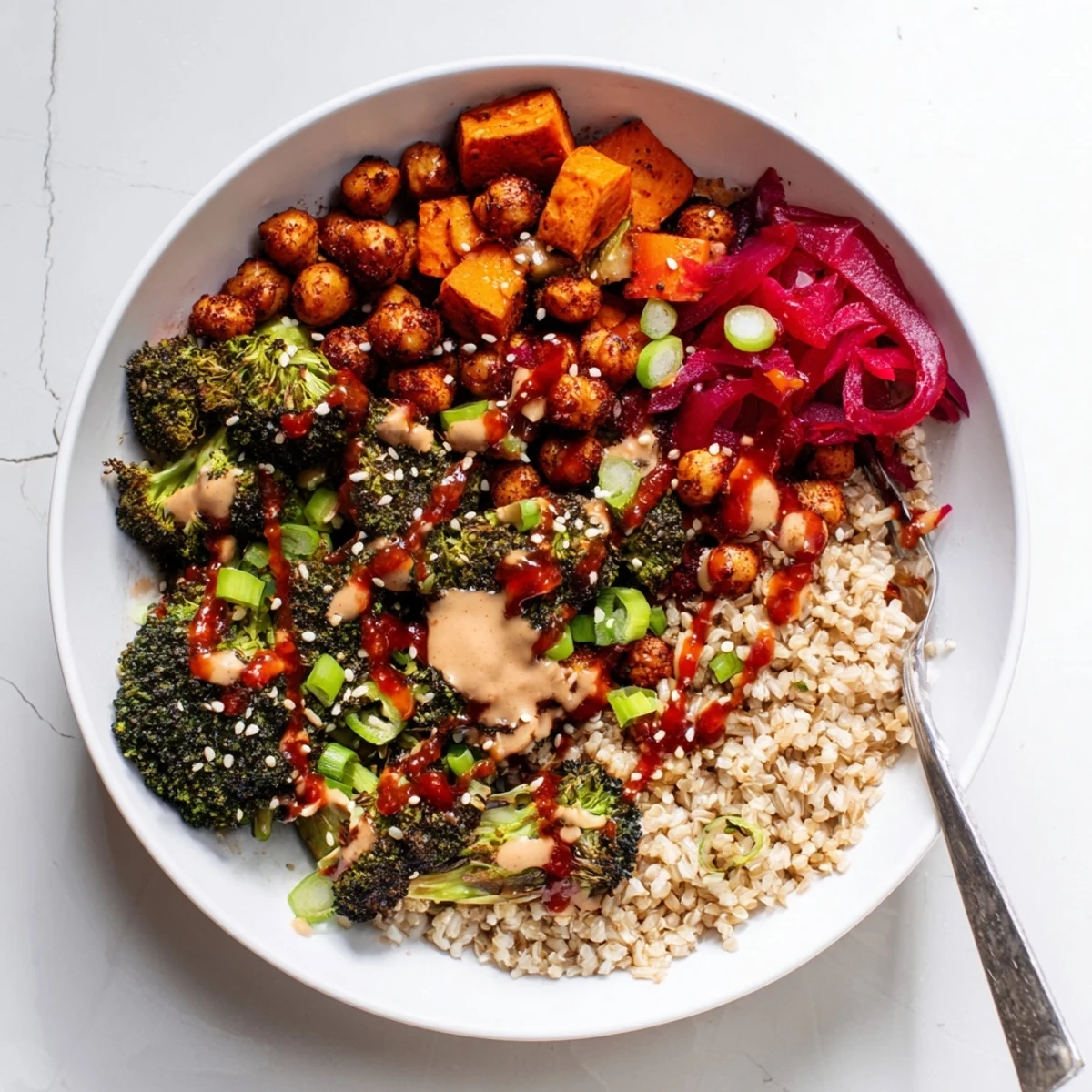Colorful grain bowls filled with roasted sweet potatoes and miso-butter drizzle.  