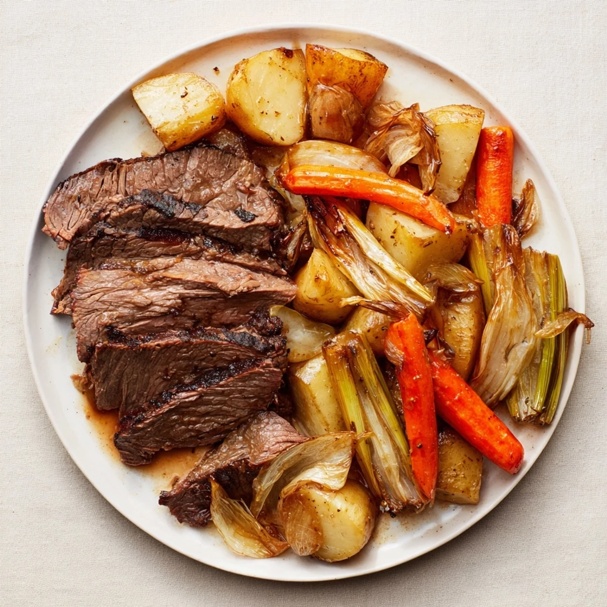 Tender Sunday Pot Roast with rosemary, thyme, and roasted vegetables, beautifully presented.