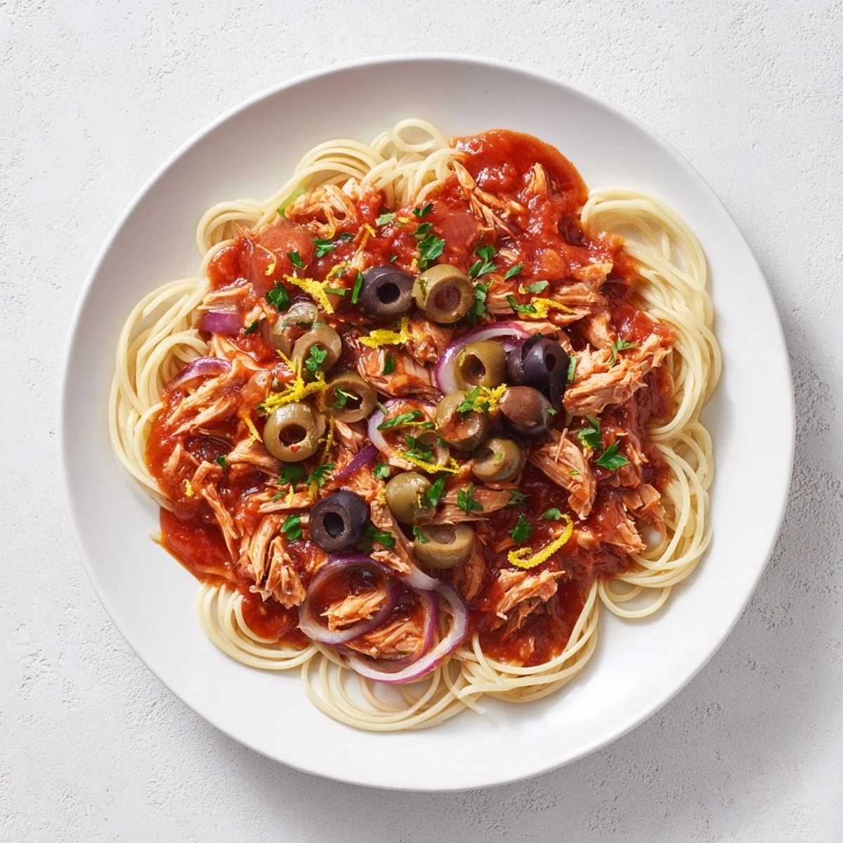 Flaky tuna, briny olives, and capers mingle with pasta in this delicious Mediterranean pasta recipe.