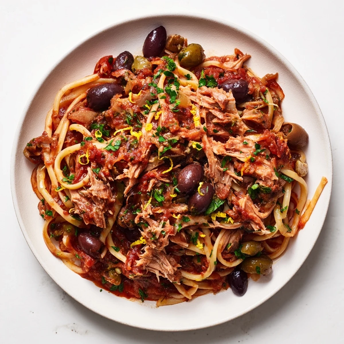 This Pasta with Tuna, Olives & Capers recipe shows a close-up of the finished, flavorful dish served.
