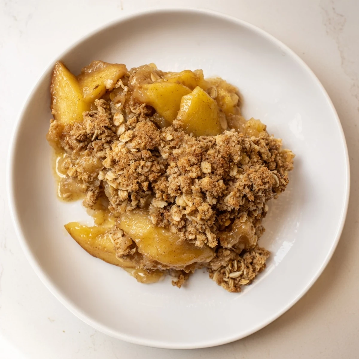 Warm, bubbling apple crisp overflowing with tender fruit and a golden oat crumble topping.