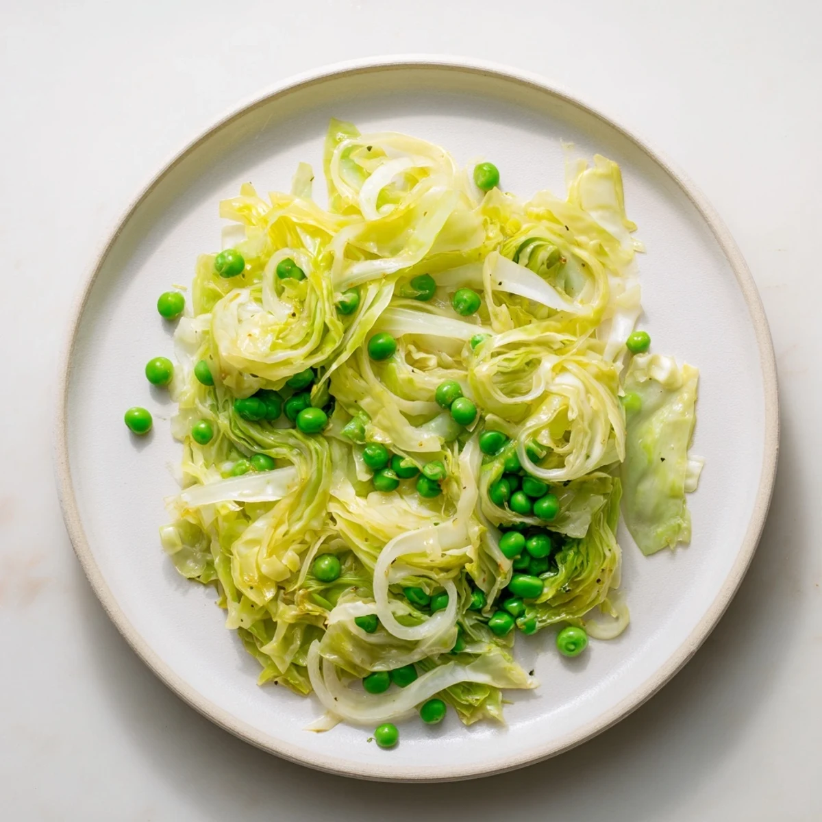 Steaming cabbage stir-fry with garlic, soy & peas, a bright veggie dish.
