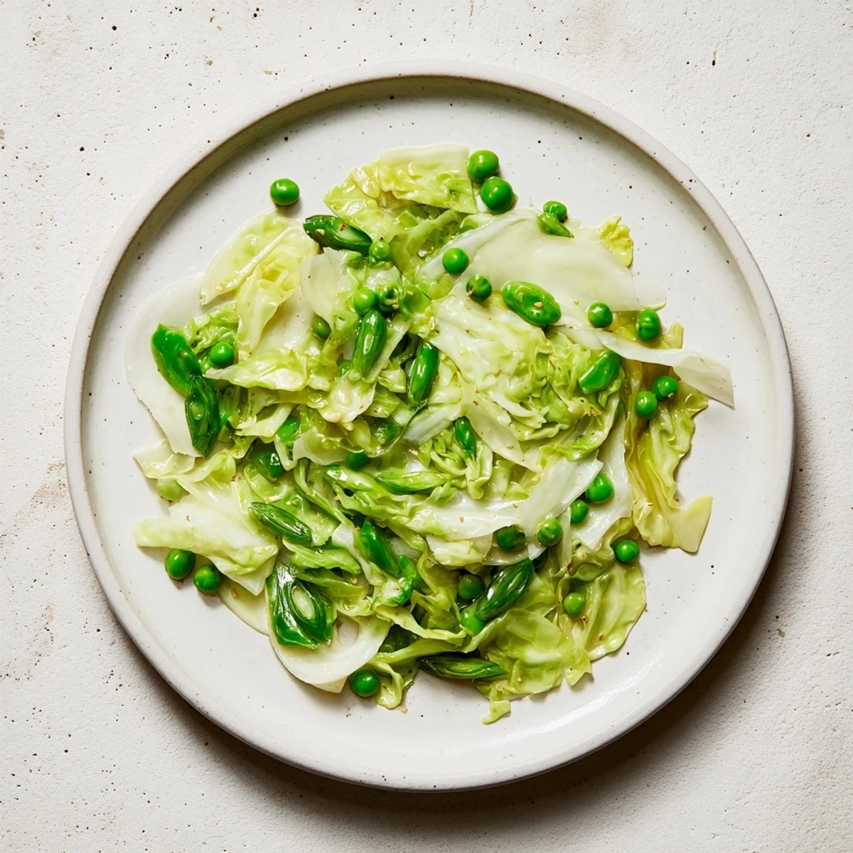 A delicious vegetarian cabbage stir-fry with tender cabbage, peas, and savory garlic-soy glaze.
