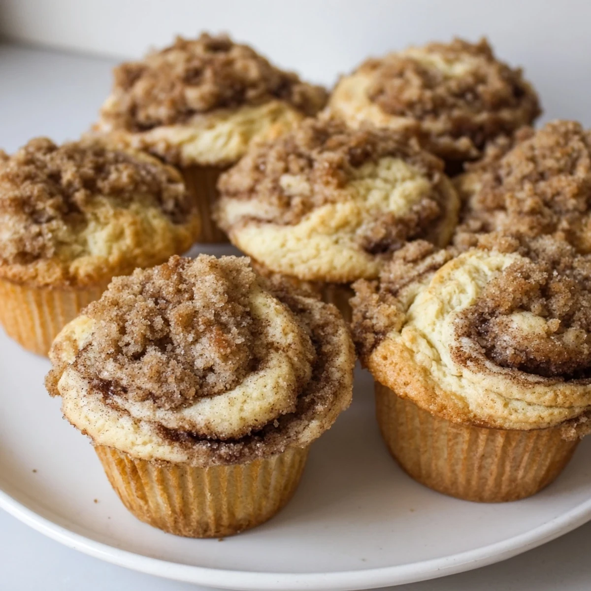 Freshly baked Lightened Christmas Coffee Cake Muffins, showcasing a lovely streusel topping and cinnamon swirl, ready to eat.