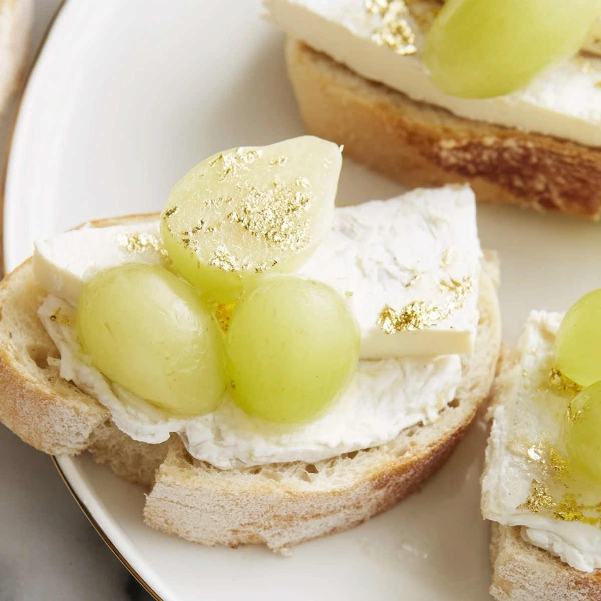 Elegant Sparkling Champagne Toast, featuring golden bread, creamy cheese, and jewel-like prosecco-soaked grapes.