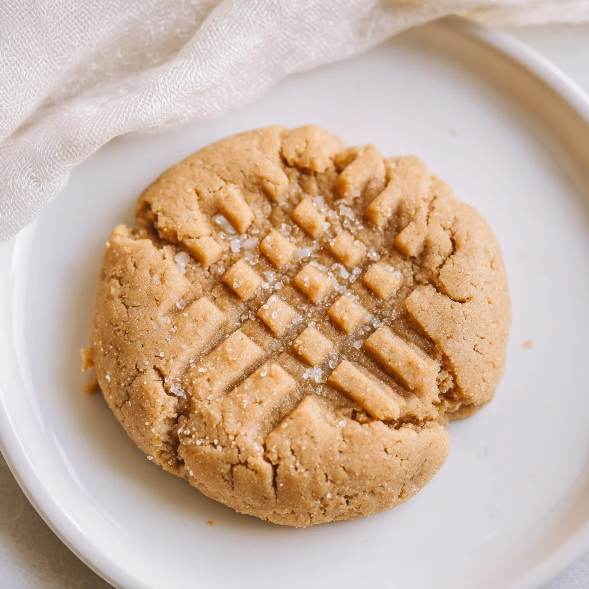 Warm, golden-brown flourless peanut butter cookies, chewy and delicious, cooling on a rack.