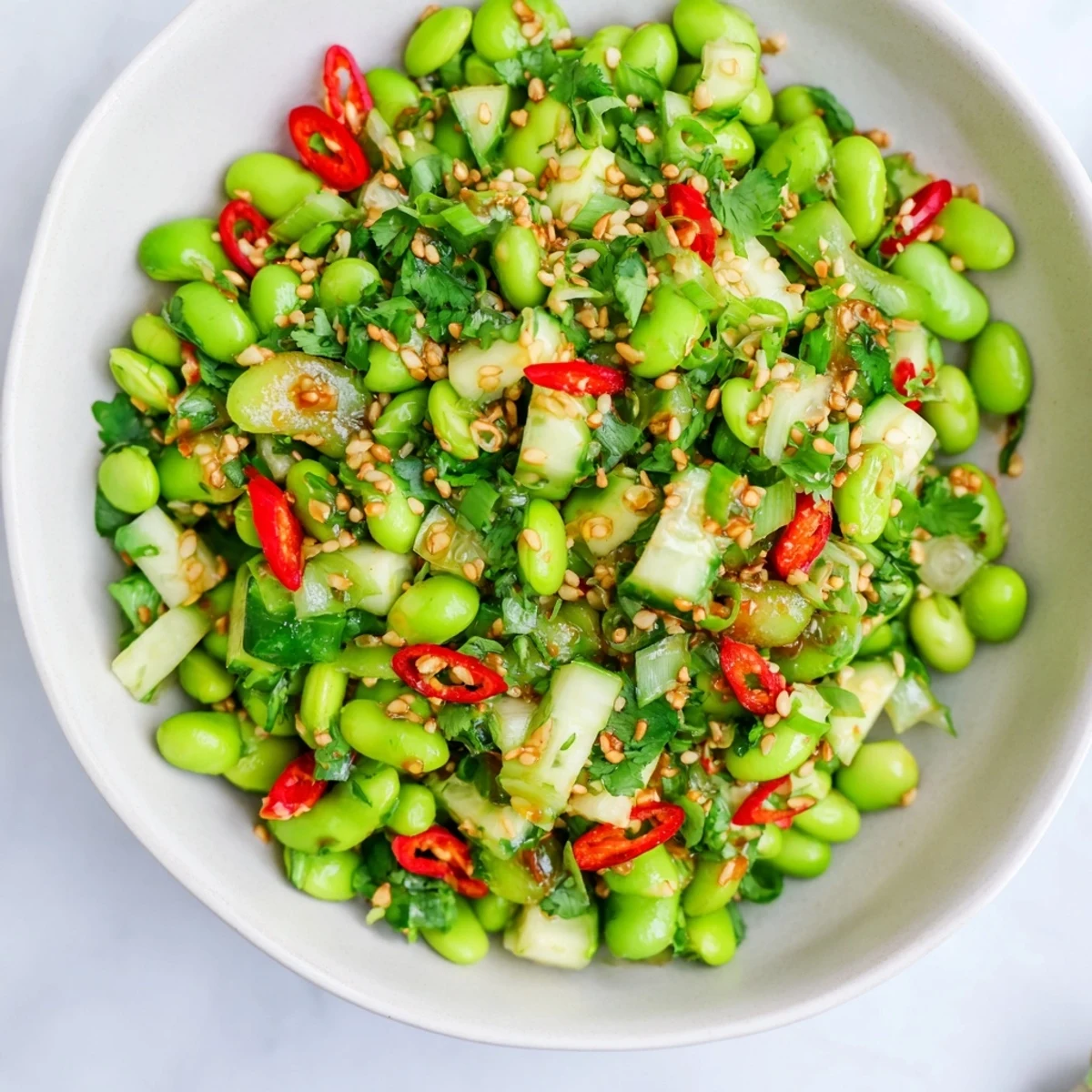 A close-up shot of the fresh edamame salad topped with sesame seeds, a refreshing summer dish.