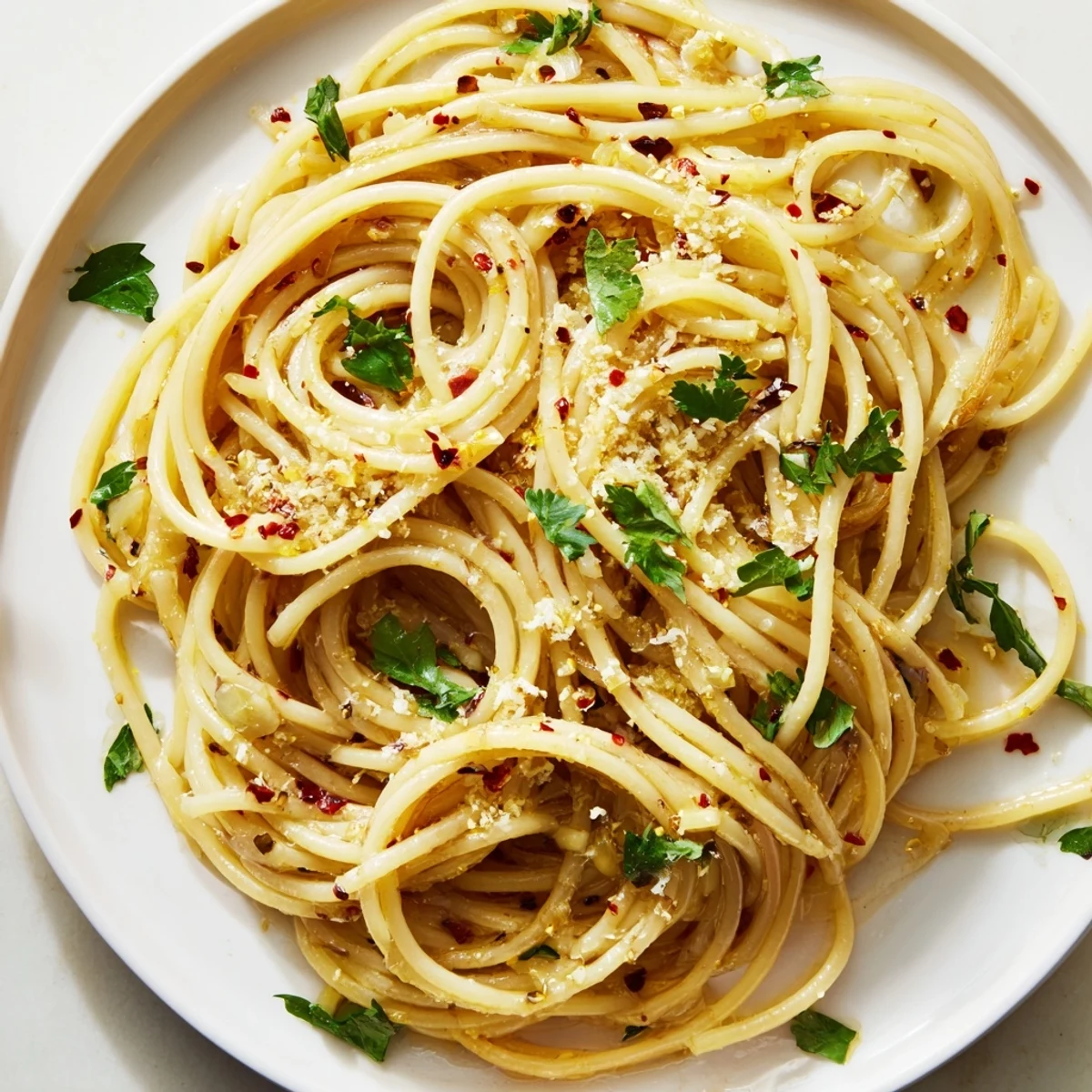 Close-up of freshly made Aglio e Olio express pasta, garnished with parsley and a sprinkle of Parmesan.