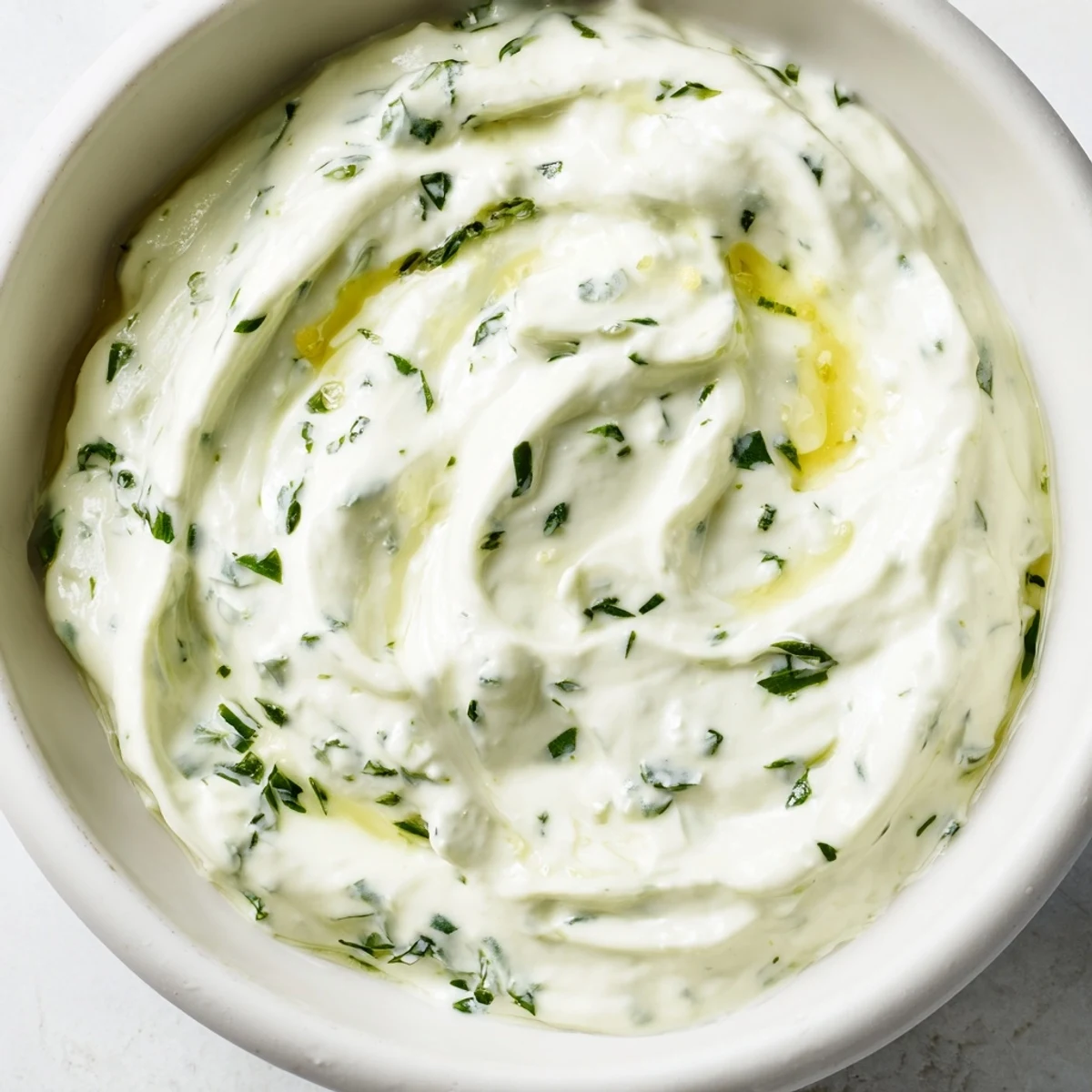 Fresh herbs blend in this Green Goddess Salad Dip for a tangy, vegetarian appetizer with tortilla chips.