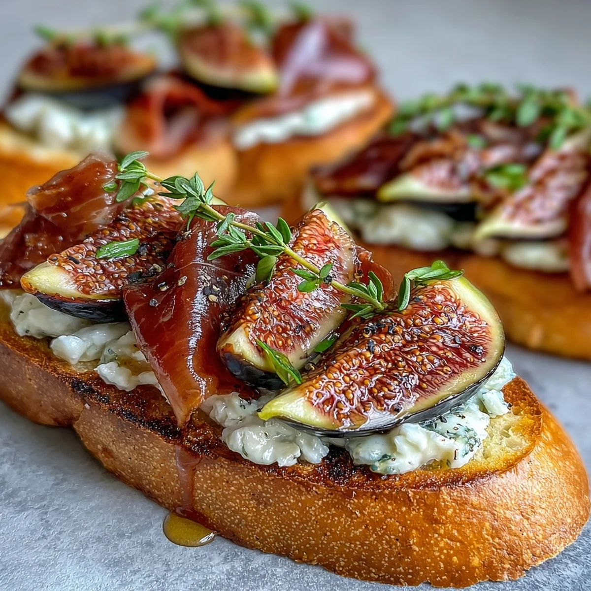 Crispy toasted bread layered with prosciutto, juicy figs, and optional creamy goat cheese, garnished with thyme.