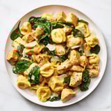 Savor the delicious Creamy Chicken and Spinach Tortellini, creamy sauce perfectly coating each tender bite.