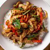 Savory Thai Basil Chicken Bowls arranged on fluffy rice, ready for a delicious dinner.