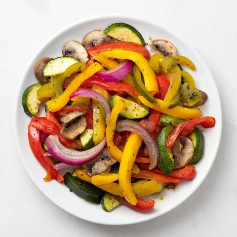Steaming Veggie Skillet Fajitas overflowing with colorful bell peppers, sizzling in a hot skillet, ready to eat.