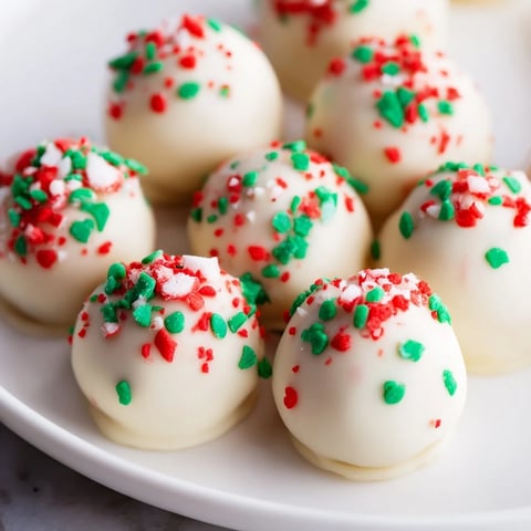 A close-up of creamy, chocolate-covered Simplified Christmas Oreo Truffles ready for festive treats.