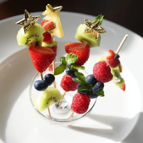 Elegant Champagne Flute Fruit Garnishes display colorful kiwi, pineapple, and strawberries ready to serve.