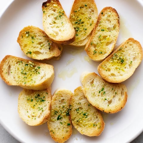 Toasted baguette slices arranged in a decorative circle, ready for serving as a tasty appetizer.