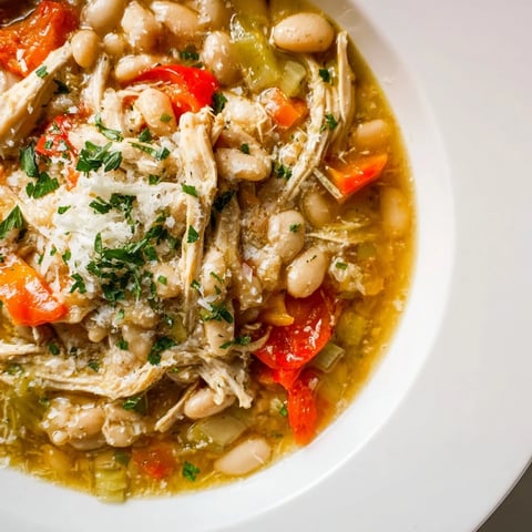 White Bean and Roasted Red Pepper Chicken stew, a comforting bowl filled with hearty ingredients.