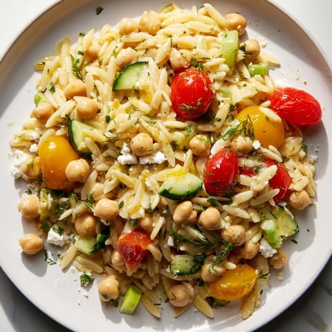 Vibrant Greek Lemon-Orzo Bean Salad with fresh dill, ready to serve as a delicious vegetarian meal.