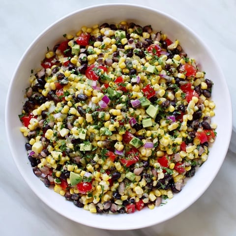 Fresh Southwestern Black Bean and Corn Salad, a colorful mix ready to eat with a vibrant lime dressing.