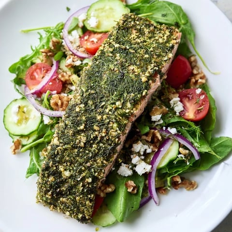 Vibrant plated herb-crusted salmon salad with fresh greens and a light vinaigrette, ready to enjoy.