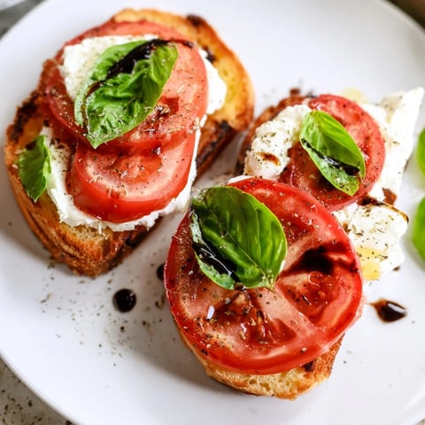 Fresh Tomato Burrata Toast: juicy tomatoes and creamy burrata on toasted sourdough, ready to enjoy.