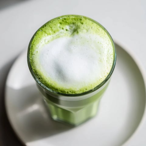 Creamy matcha latte, a picture of frothy green drink, topped with sweet, pillowy cold foam.
