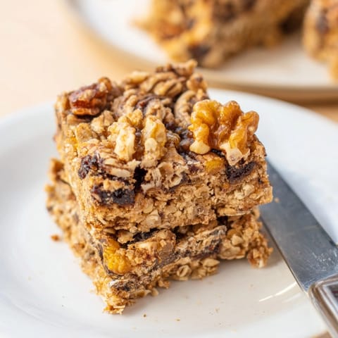 Close-up of homemade Peanut Butter Cinnamon Raisin Bars, showing texture and sweet raisin bites.