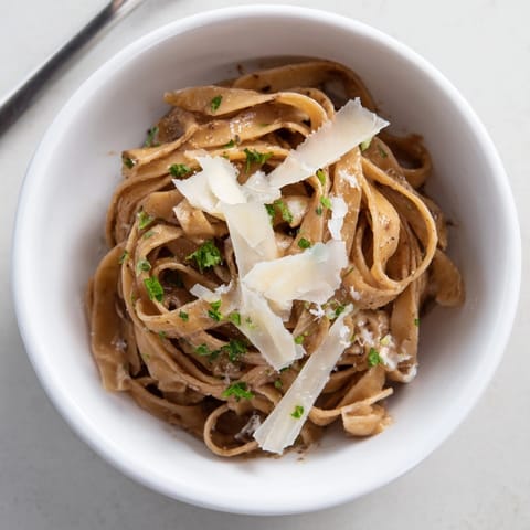 Bowl of creamy Garlic Browned Butter Noodle Bowls with parmesan and fresh parsley.