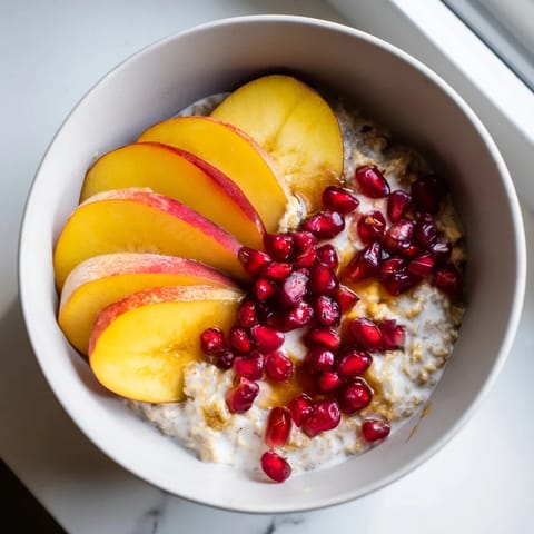 A close-up of Overnight Oats with persimmon, showcasing the colorful pomegranate and chia seed topping.