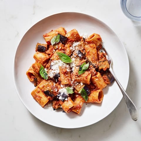 A hearty bowl of vegetarian Pasta Alla Norma features tender eggplant and rich tomato sauce, ready for a Sicilian-inspired dinner.