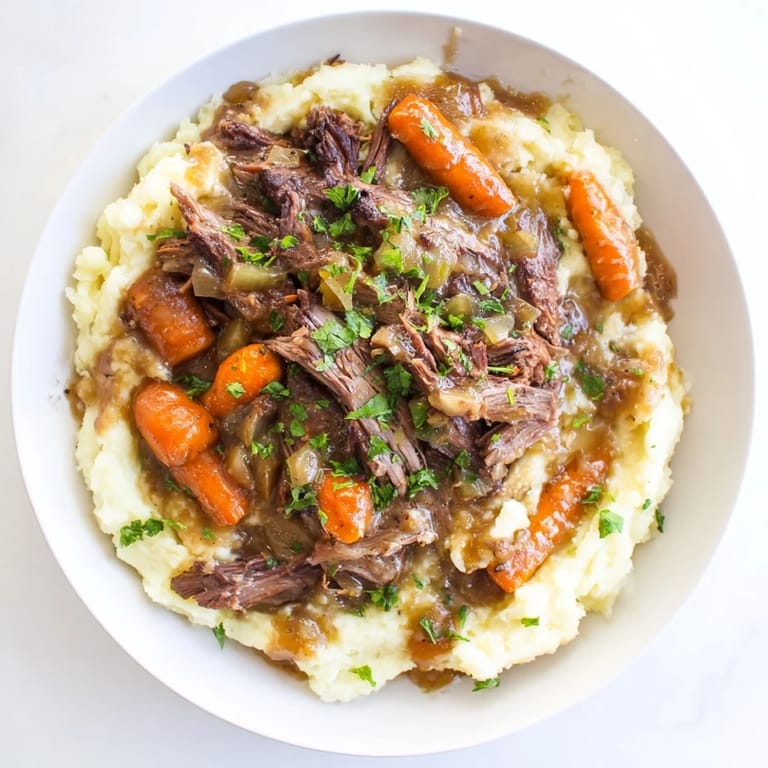 This close-up shows juicy pot roast, carrots, and potatoes, creating a delightful American cuisine presentation.