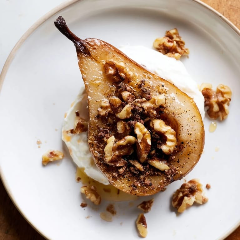 Close-up of baked roasted pears, finished with honey, crunchy walnuts, and Greek yogurt.