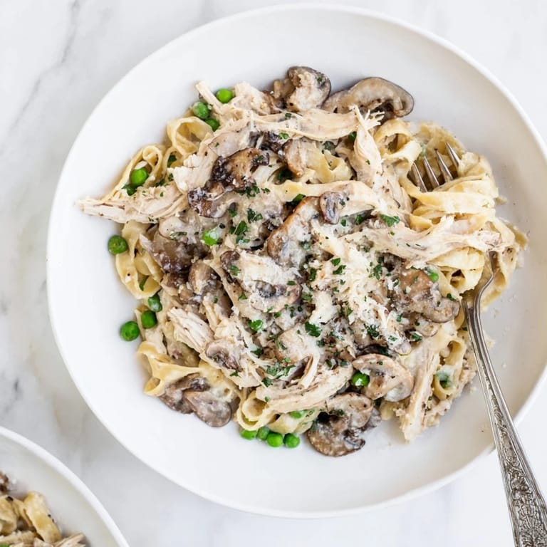 This comforting Creamy Chicken Alfredo slow-cooker meal features thick, rich Alfredo sauce with herbs.