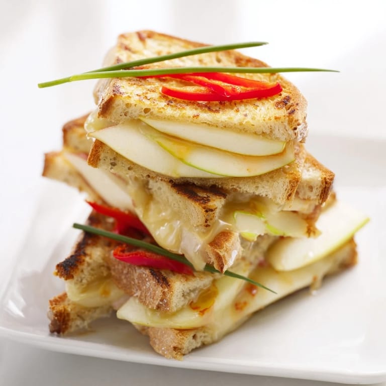 Melted Brie, sweet apple slices, and honey create this festive Brie, Apple & Honey Christmas Candle Grilled Cheese.