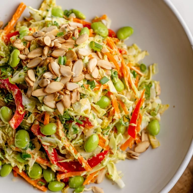 Fresh, zesty Crunchy Cabbage and Edamame Salad topped with crunchy almonds and sunflower seeds, ready to eat!