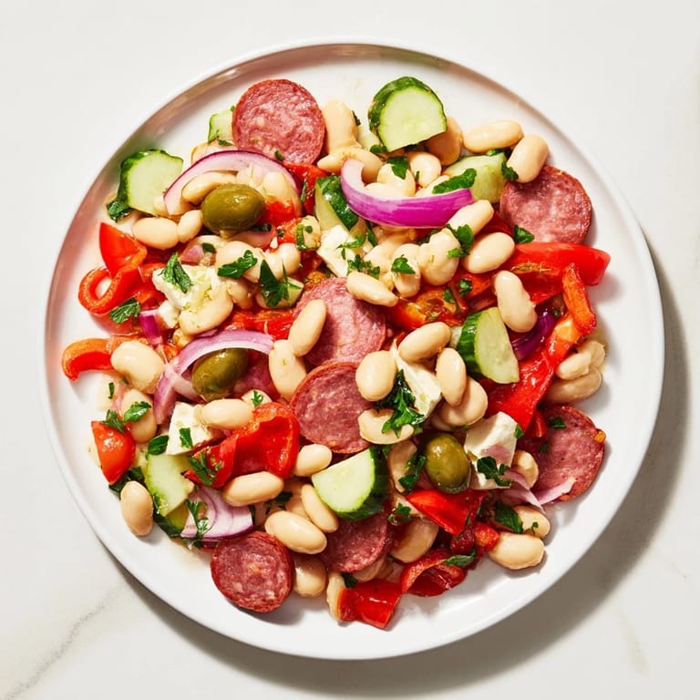 Freshly tossed Italian Antipasto Bean Salad with vibrant red tomatoes and creamy cannellini beans.