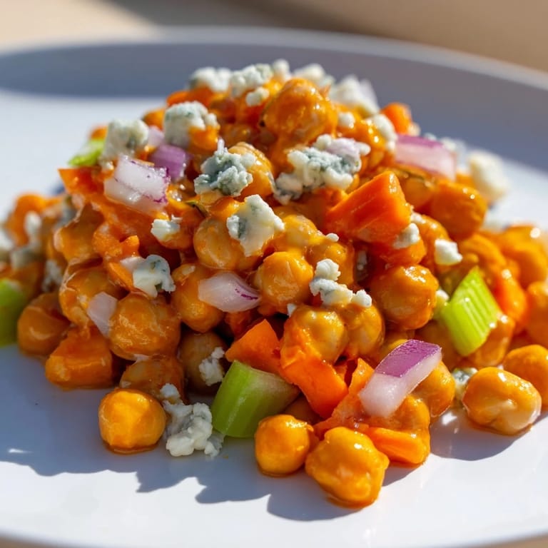 This refreshing buffalo chicken bean salad features diced carrots and celery mixed with creamy dressing.