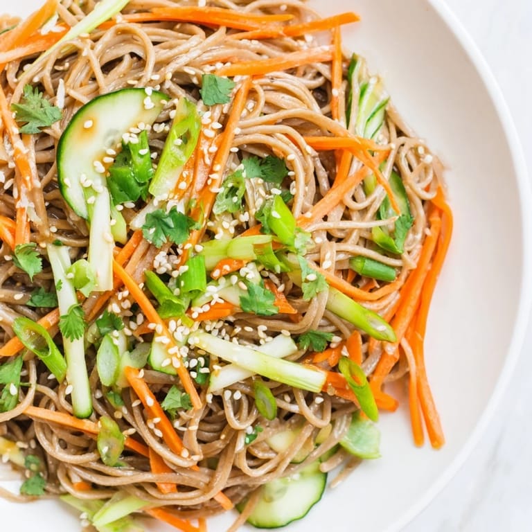 Savory Chilled Noodle Lunch Cups feature tender noodles with julienned vegetables and a delicious drizzle of sauce.